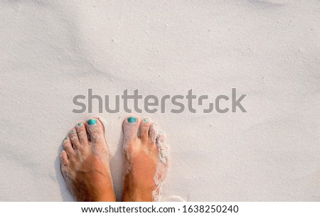 White sand texture woman feet. Relaxed tourist on beach. Tropical vacation banner template with text place. Summer vacation background. Bare feet girl on coral beach. Smooth sunny sand beach