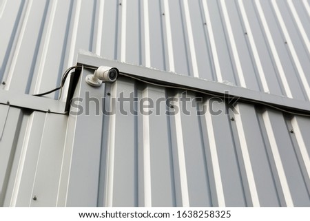 security camera on a metal wall