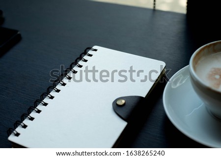 notebook and pen on a black table, notebook on table in cafe