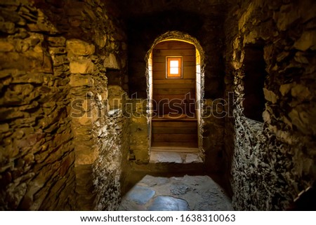 toilet with a window in an old stone castle Royalty-Free Stock Photo #1638310063