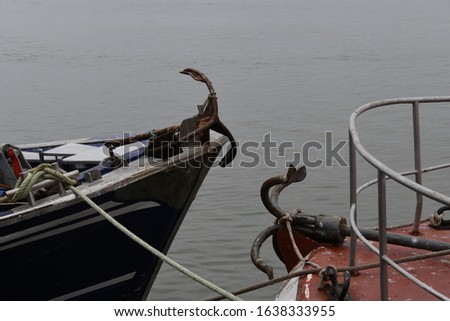 a rope for the net of fishermen and an anchor on a boat in the port of Isla Cristina, Huelva province, Spain