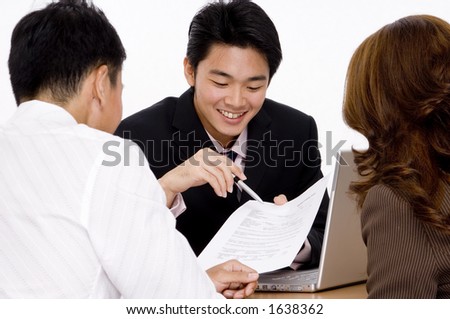 A young employee helps a couple with a form Royalty-Free Stock Photo #1638362