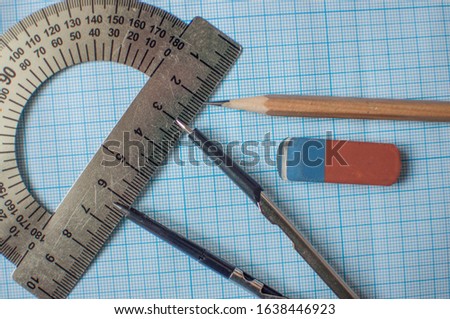 Mathematics geometry tool for student in math class with copy space for text on paper graph background. Mathematics concept