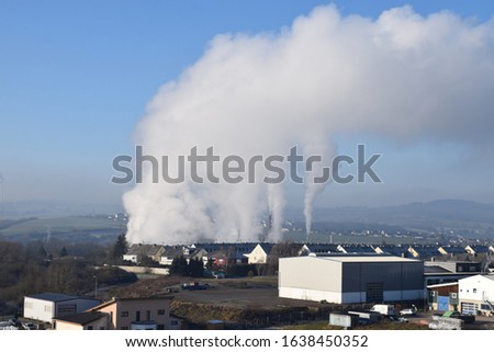 smoke over small town Mayen in winter
