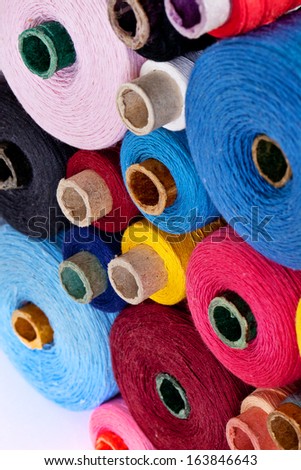 close up of spools of thread of different size, texture and colour