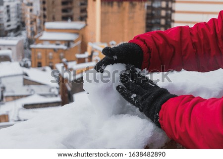 Detailed shot of a young man playing with the snow. Lifestyle and winter concept