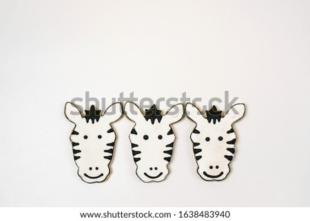 Three cookies decorated as zebras