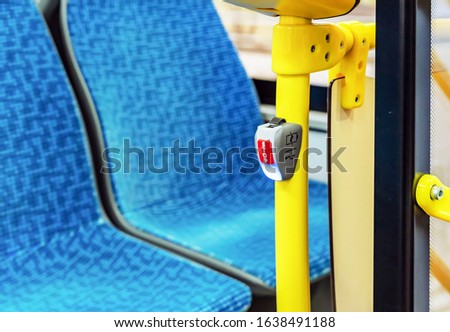 Red stop button in public transport. Bus stop button at the request of the passenger.