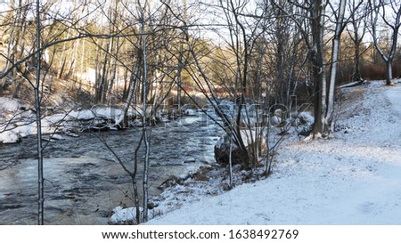 The winding river flows beautifully on a sunny winter day.
