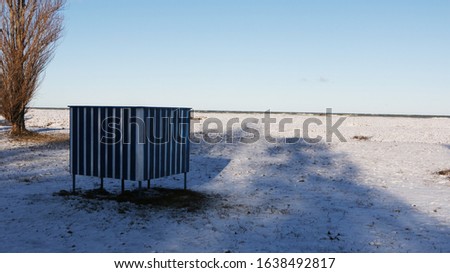 Background - landscape, beautiful view of the beach on the seashore in winter.. There is a storm at sea.