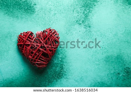 
Heart on an emerald background with place for text. Valentine's Day. Top view