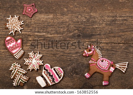 Christmas gingerbread cookies over wooden background