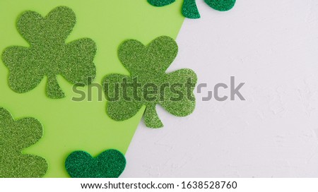 St. Patrick's Day background with glitter green clovers and copy space.