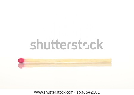 One wooden match on a white background.