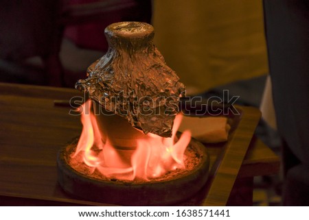 Traditional Turkish Testi Kebab - Tandir - Pottery Kebab cooked in clay pt over fire in Istanbul. Royalty-Free Stock Photo #1638571441