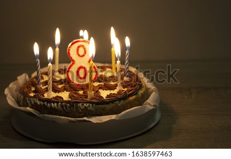 cake background. Cake with candles and the number eight. Child's birthday. Celebration atmosphere. copyspace