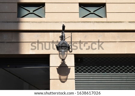 Vintage Black Iron Hanging Lamp on Wall Bracket of Commercial Building in Spain 