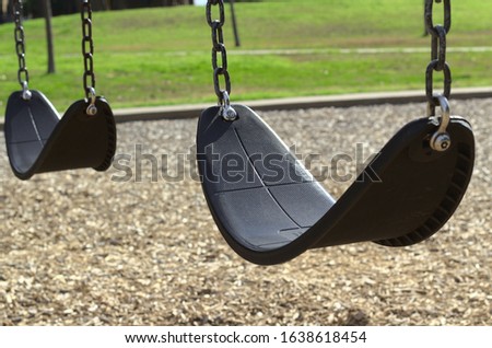 A swingset in a sunny park Royalty-Free Stock Photo #1638618454