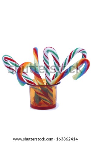 Christmas lollipops in a cup Isolated on white 