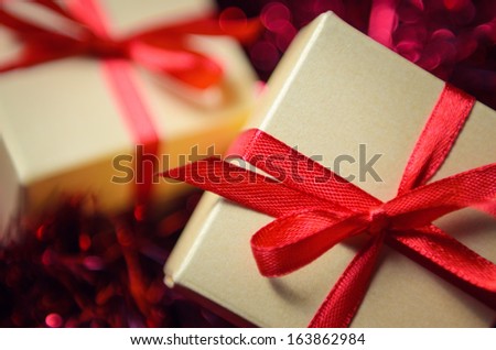 Gift boxes with red ribbon on abstract background