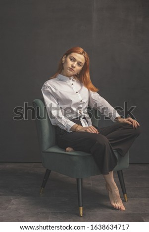 Red-haired girl on a dark background shows different emotions