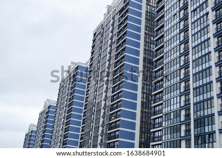 New modern tall blue glass multi-storey comfortable urban monolithic frame houses buildings skyscrapers new buildings in the big city of the megalopolis.