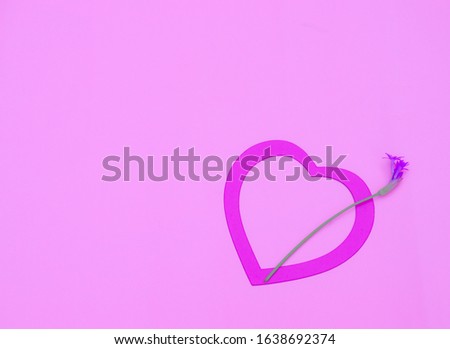 Pink heart with a little flower on pastel pink background. Valentines day, Mother day or celebration concept. Birthday greeting card.