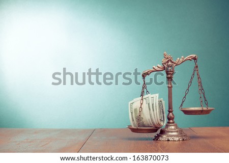 Law scales and cash money on table concept photo