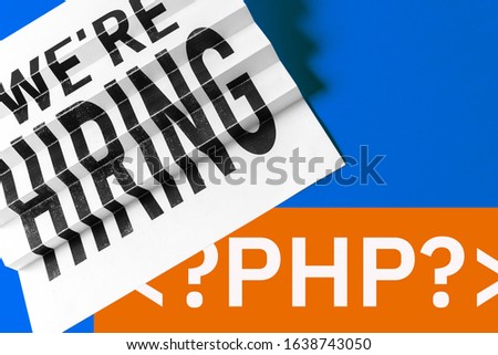 PHP programming language. Paper keyboard or ladders concept with php tag on blue background.