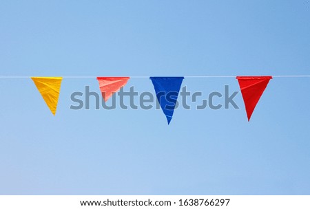 colorful triangle party flags on sky background for decoration