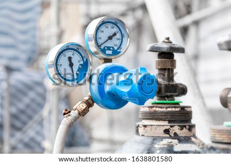 Close up of pressure gauges on oxygen tank with valve of welding equipment acetylene gas cylinder for steel Industrial and metal working construction. Royalty-Free Stock Photo #1638801580
