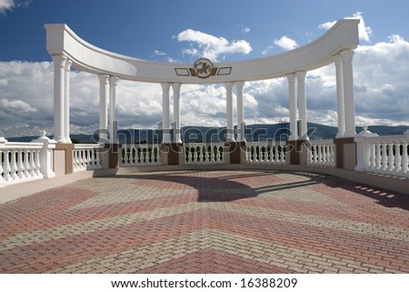 Arch with white columns on a background of the dark blue sky.