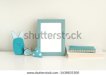 Kids room interior, mock up of blue photo frame, work desk with blank frame for poster, art, text.                  
