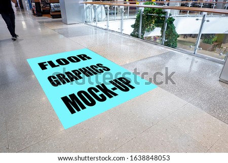 Mock up perspective blank vertical screen on floor with clipping path on walkway in shopping mall, empty space for insert graphic or text information or warning word