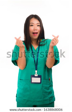 young beautiful and happy Asian Korean medicine doctor woman or hospital nurse in green scrubs posing cheerful smiling confident in corporate clinic staff portrait on isolated white background