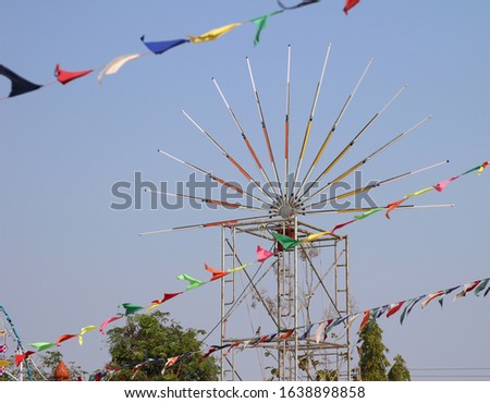 Colorful triangle party flags with fluorescent light bulb for decoration at temple Thailand.