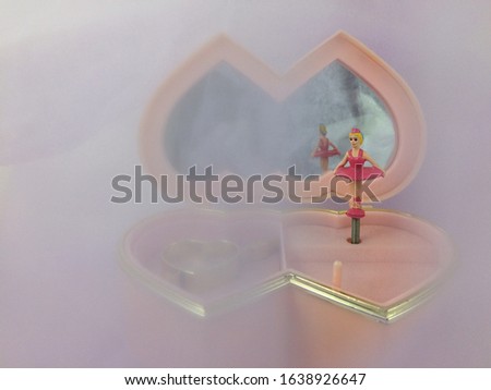 Ballerina dancing girl pink music box. Blurs background. Dream pink love concept. Mist idea.