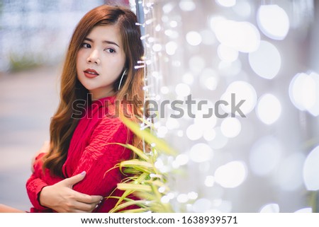 Beautiful Asian-Thai woman in New Year festival with beautiful lighting bokeh background