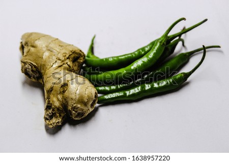 A picture of green chilies with ginger