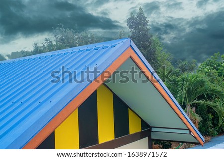 Half-round blue gable attic, covered with tiles, smooth plan, sanctuary on horizontal vinyl scoop, siding in new luxury construction, Thai family home, detached house in the east coast of Thailand 
