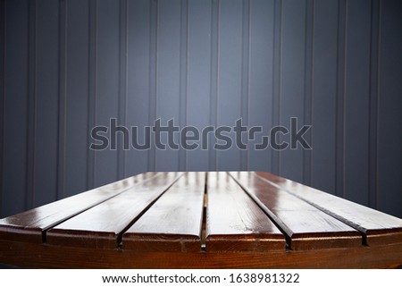 Empty wooden table, old wooden background for product montage and presentation. Dark interior template. Illustration of photo texture.