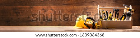 Safety Equipment's Near Toolbox With Various Work Tools On Wooden Surface Royalty-Free Stock Photo #1639064368