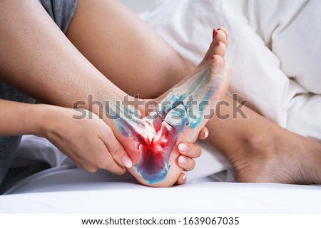 Woman Feeling Achilles Heel Pain In Bed Royalty-Free Stock Photo #1639067035