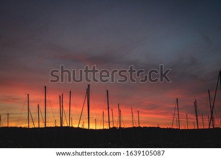 beautiful scenic view of sailing boats silhouettes in magic colorful sky, 