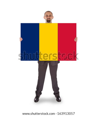 Smiling businessman holding a big card, flag of Chad