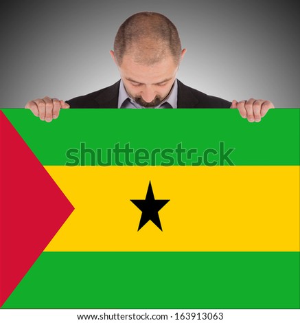 Smiling businessman holding a big card, flag of Sao Tome and Principe