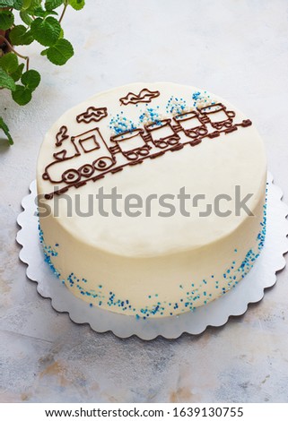 children's cake with the image of a steam locomotive on the table, a cake for the boy.