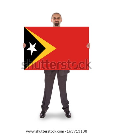 Smiling businessman holding a big card, flag of East Timor