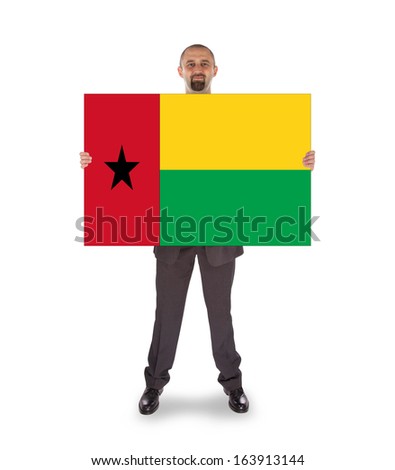 Smiling businessman holding a big card, flag of Guinea-Bissau