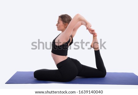 photo of woman in studiou practicing yoga over white background